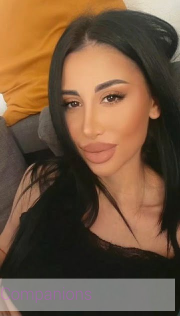 A London call-girl taking a selfie with her cute smile and naturally pretty features