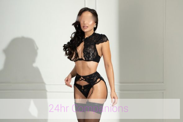 An elegant companion radiates charm in a captivating photo session.