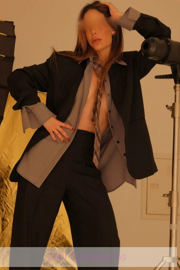 Vienna gracefully showcases her long legs, which perfectly complement her fashionable outfit.