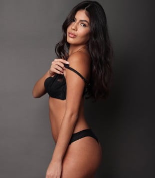 Agency escort Emelda in her sexy lingerie, looking sensual