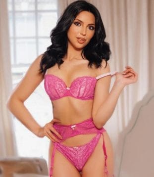 Escort Jayne exudes sensuality and grace in a glamorous pose.