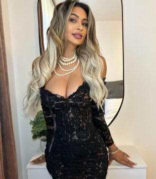 Jessica gracefully showcases her cute figure, which perfectly complements her fashionable outfit.